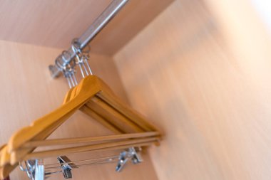 Birçok ahşap kahverengi askı oteldeki bir çubukta.