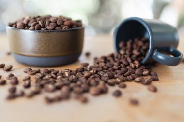 Ahşap masadaki kavrulmuş kahve çekirdeklerine bakın.