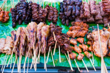 Geleneksel Tayland sokak yemekleri ve yerel markette ahşap bir çubukta ızgara yiyecek. Bangkok sokak yemekleri