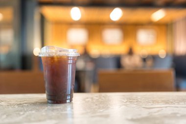 Bokeh light arka planda bir fincan buzlu kahve Americano.