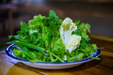 Taze sebze tabağı, salata ve kişniş gibi.