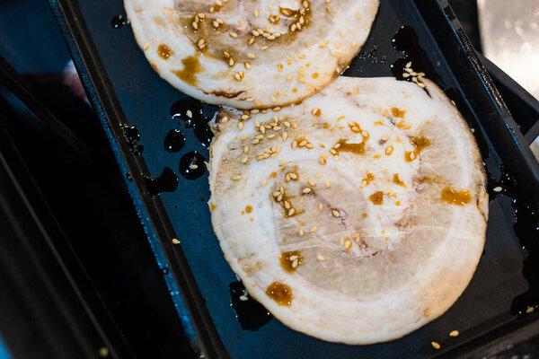 Chashu pork is a Japanese-style seasoned pork dish served on black tray