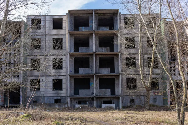 Abandoned and unfinished apartment building. Front view.