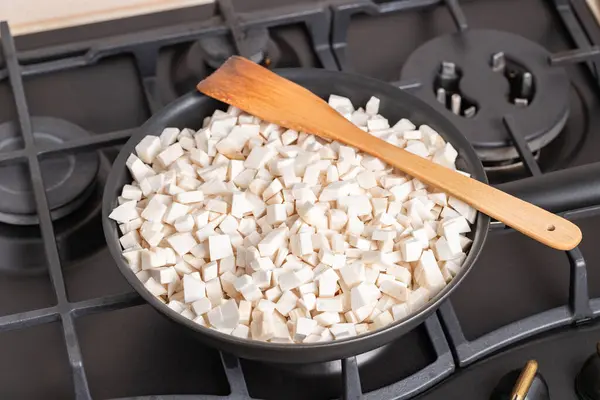 stock image Frying pan full of chopped, fresh bay boletes and boletus or king oyster mushrooms or eryngii (Pleurotus eryngii) during the process of frying. Frying mushrooms in a fry pan. Close-up.