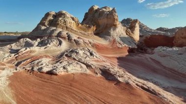 Sunset flyover of red and white sandstone, high buttes - White Pocket, Arizona