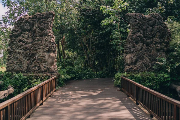 Sacred monkey forest sanctuary gates. Bridge to forest in ubud, stone carved entrance gates