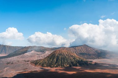 Bulutlu gökyüzü olan bir volkan manzarası. Misty bromo tengger Semeru Ulusal Parkı