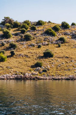 Amazing landscape with sea bay, rocky dry beach of Dugi Otok island in Adriatic Sea, Croatia clipart