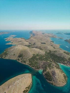 Drone aerial view of Kornati archipelago in Croatia, islands with coniferous trees growing on hillsides clipart