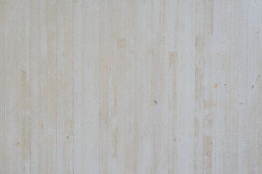 Detaylı dokuları ve ince kusurları gösteren beton bir yüzeye yakından bakın. Ham, endüstriyel estetik materyallerin doğal özelliklerini vurgular..