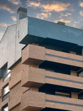 Günbatımında Valencia 'daki modern apartman. Çağdaş bir şehir ortamındaki eşsiz mimari tasarımı ve sakin kentsel yaşam atmosferini vurgular.