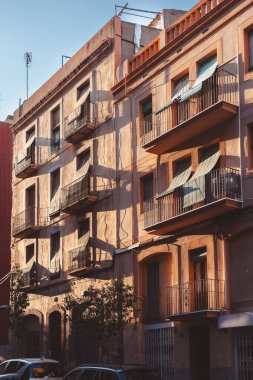 A captivating view of city buildings casting shadows during golden hour, beautifully highlighting their charm in Tarragona, Spain