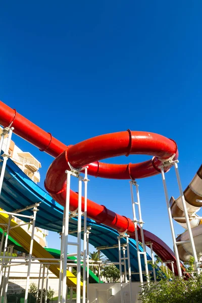 stock image Water slides, bright multi-colored water splash fun games. Safe childrens playground without people on a summer day.