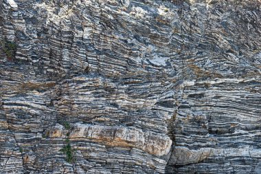 Nature force compressed cracked rock layers structure formation close-up details, in various shapes, colors, thicknesses, at south central coast of Crete, Greece. Nature, Geological science concept clipart