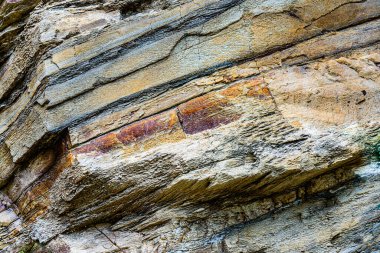 Nature force compressed cracked rock layers structure formation close-up details, in various shapes, colors, thicknesses, at north central coast of Crete, Greece. Nature and Geological science concept clipart