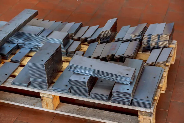 The cut sheet metal is stacked on a pallet for further processing. Modern cutting of metal with a laser machine.