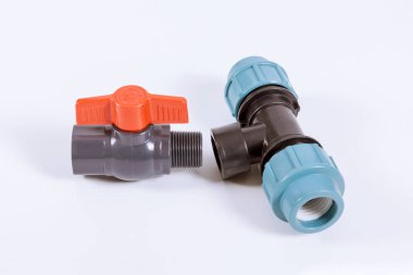 Plastic water pipe connector plumbing hose fittings. Black coupling for connecting plastic pipes on a white background. Residential water supply system components.