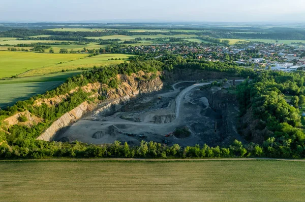 Top view of stone quarry, loading of stone ore, industrial panorama in countryside.