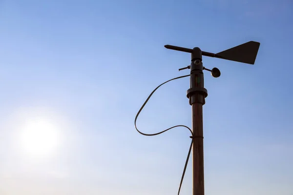 stock image Wind wheel and anemometer on the background of clear blue sky. Measurement of wind speed and direction.