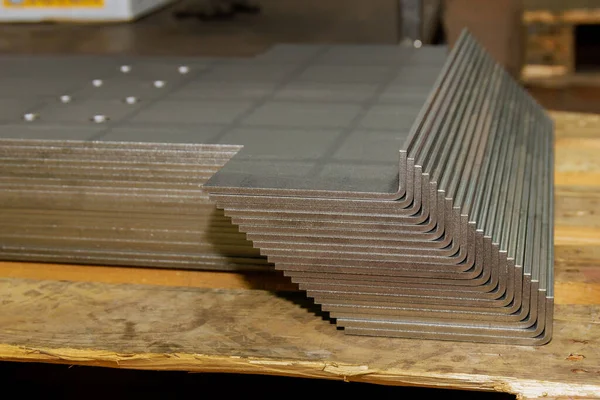 Metal sheet bending. Sheet metal products are stacked on a pallet after a bending process.