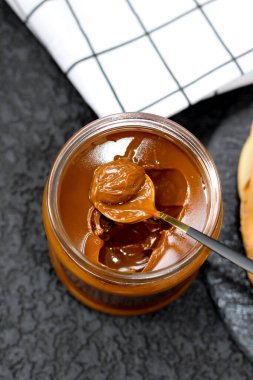 Yoğunlaştırılmış sütle dolu kavanoz yayılmayı bekliyor, süper lezzetli. 