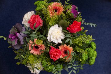 Profesyonel bir çiçekçi, Gerbera çiçekleri, karanfil gülü, okaliptüs yeşilliği tarafından yapılan şenlik buketi.