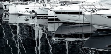 yachts and motor boat in marina port, front view