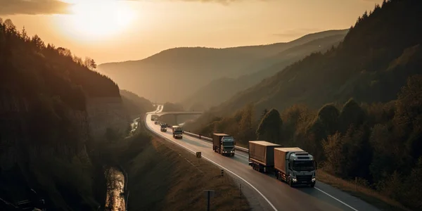 Trucks on highway in mountain at sunset