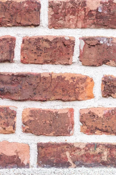 stock image Massive stone wall with rough rocks like a castle wall with different bricks as natural background and rocky wall of ancient times shows solid bricks of stones as vintage texture for granite minerals