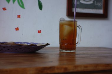 Tahta masada bir bardak buzlu çay.