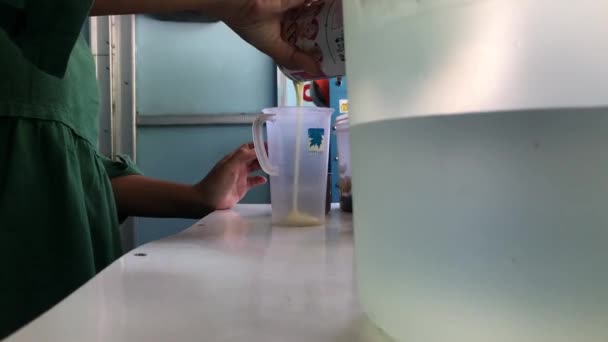 Pouring White Milk Plastic Cup — Vídeo de Stock