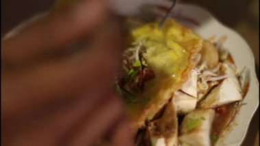 Seçici odaklanma kupat tahu blabak 'ı hazırlıyor. Geleneksel yiyecek olarak dilimlenmiş tofu, pirinç keki, kasava keki, inek bacağı, erişte ve siyah karides ezmesi çorbası var..