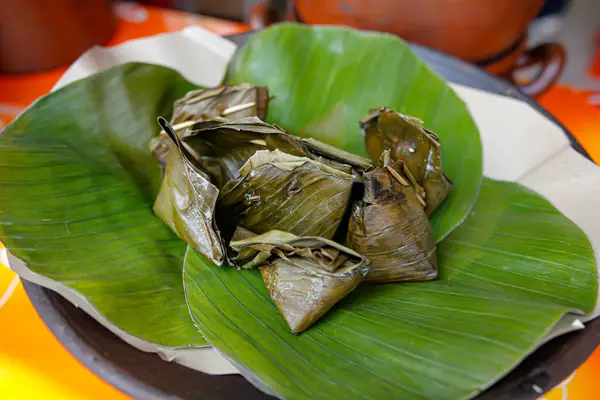 Balinese grilled betutu chicken wrapped in banana leaves and grilled on banana leaves