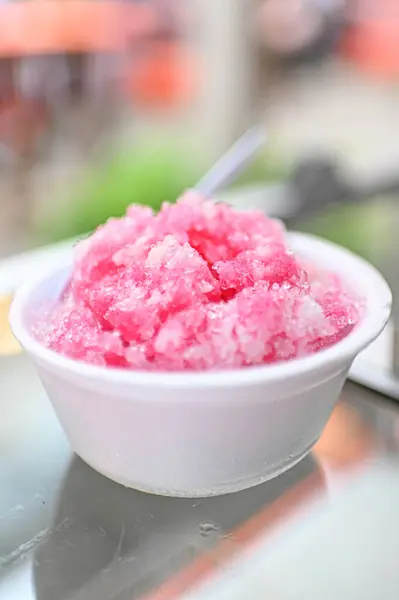 Shaved ice in a white bowl with a bokeh background
