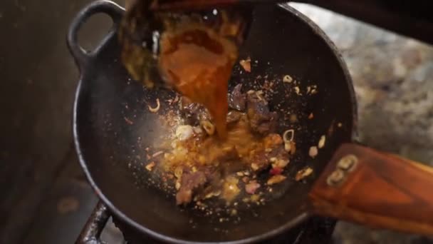 Matlagning Tongseng Nötkött Och Lägga Till Sås Omrörning Med Slev — Stockvideo