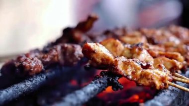 Biftek satay ve tavuk satay 'ı birlikte yakın. Yan manzara, sokak yemekleri.