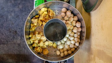 Cuanki meatballs in a pan seen from above clipart