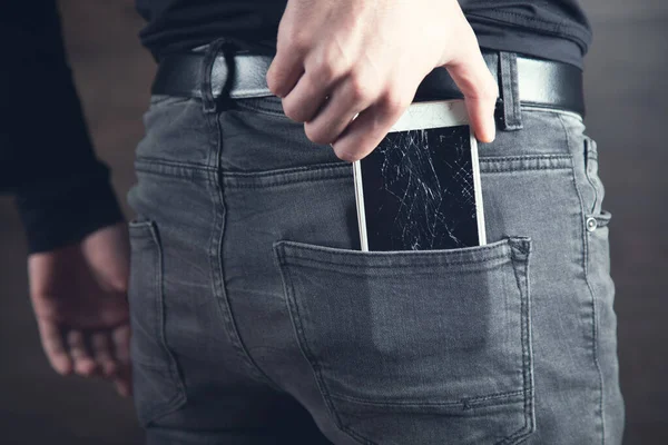 man hand in pocket broken phone