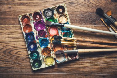 Arkaplanda fırçalar olan suluboya