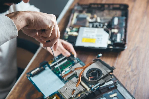 stock image worker man repairing computer on the desk