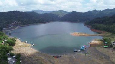 Sempor rezervuar barajının veya Gombong Kebumen 'deki Waduk Sempor, Central Java, Endonezya' daki bulutların, tepelerin ve yeşil ağaçların hava aracı görüntüsü