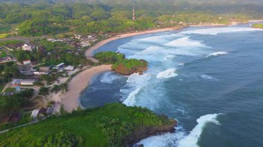 Beyaz kumlu, mercan kayalıklı, yeşil ağaçlı, Krakal Sahili 'nden, Gunung Kidul' den, Yogyakarta 'dan okyanus dalgalı hava aracı görüntüsü.