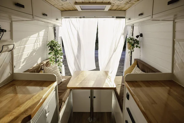 Interior of a Nordic-style handcrafted campervan at sunsetTransportation, travel, tourism, vacation, lifestyle
