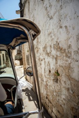 Locorotondo, Puglia, İtalya 'daki Picturesque caddesi, bir tuk-tuk' un içinden görülüyor. Seyahat, ulaşım, tatil, eğlence, turizm