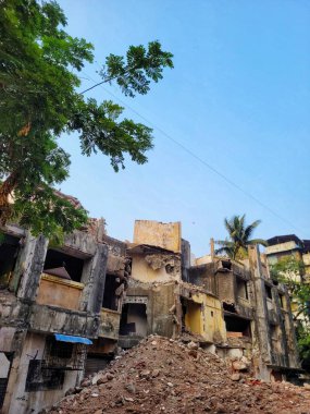 Güneşli bir günde, açık mavi gökyüzünün altındaki terk edilmiş bir binanın altından.