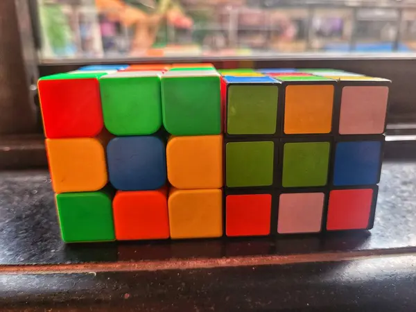 Kısmen çözülmüş bir Rubiks küpünün pencere pervazına yakın plan görüntüsü