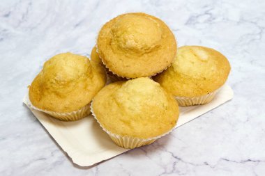 tray with homemade muffins on marble table