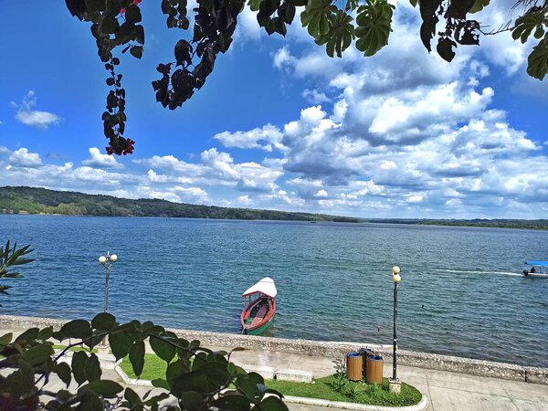 Lake Peten Itza's Tranquil Beauty: Flores Island and a Boat Grace the Picture-Perfect Setting in Peten, Guatemala