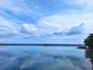Reflections of Clouds on the Tranquil Waters of Lake Peten Itza in San Andres, Guatemala