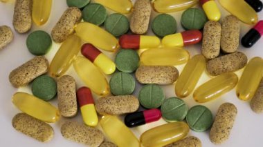 Assortment of different pills close-up. The topic of health care, treatment and prevention of diseases.